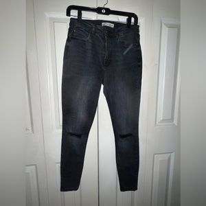 Black skinny jeans with rips in the knees
